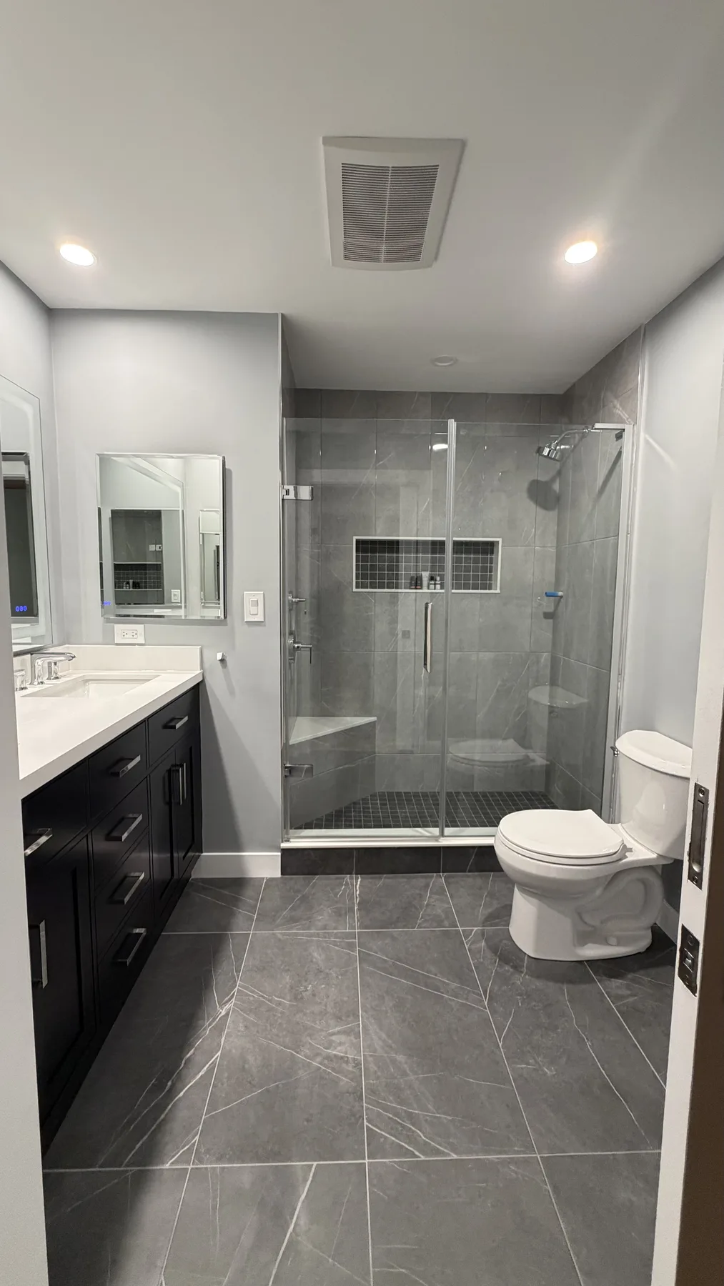 Full bathroom remodel with modern tile and glass shower by Wolf Carpenters