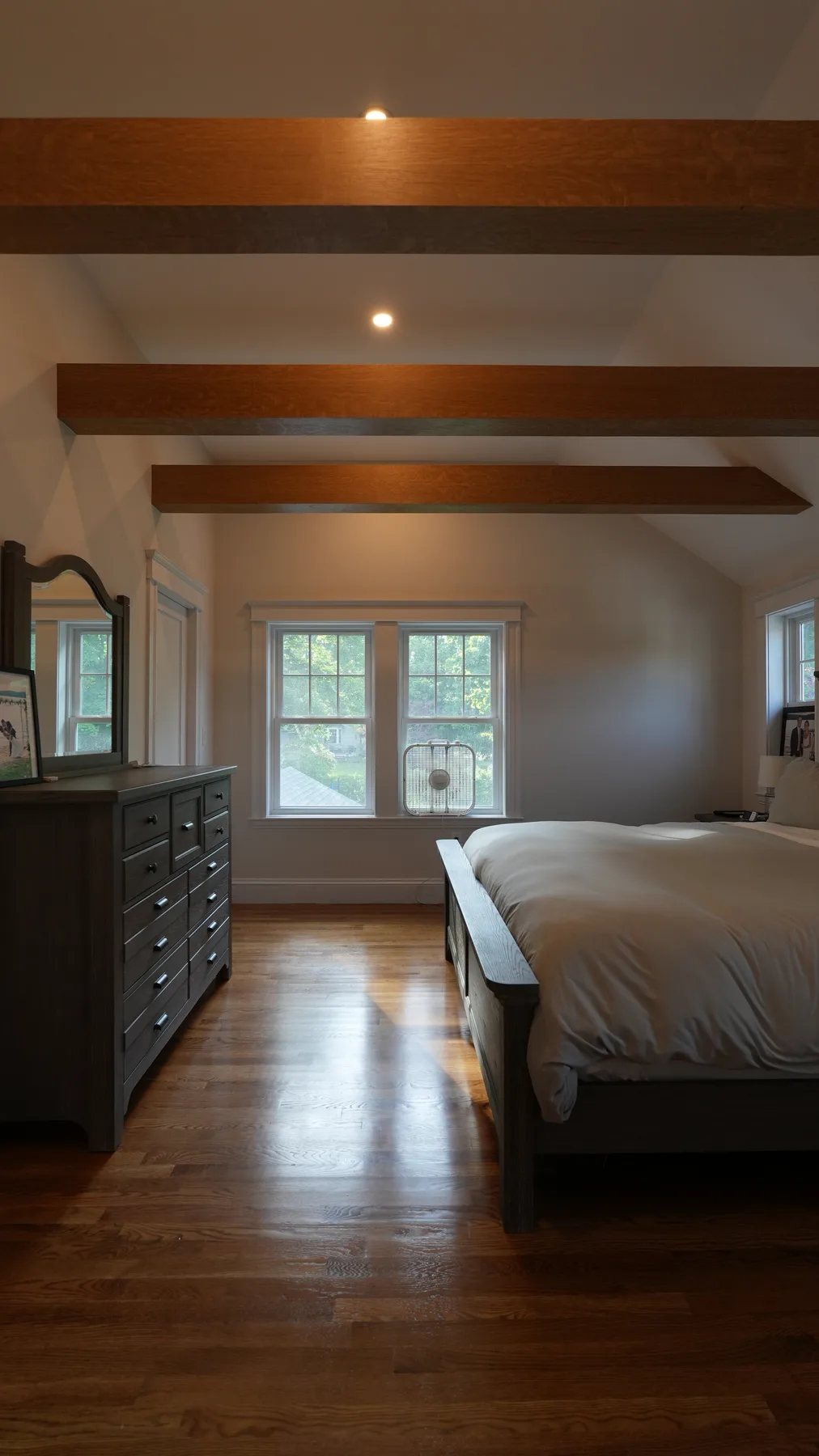 Custom bedroom remodel with wood paneling and built-in storage by Wolf Carpenters