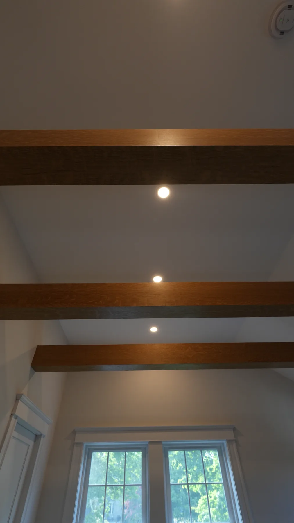 Bedroom remodel with warm wood accent walls, North Shore MA