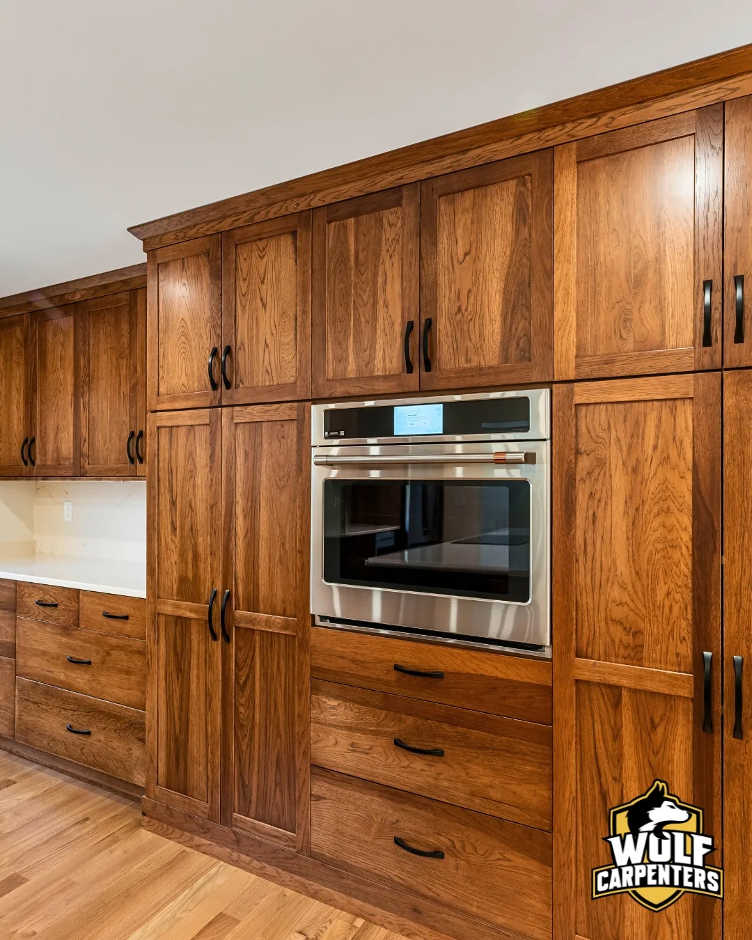 Custom hickory wood kitchen cabinets with a built-in wall oven in a North Andover, MA kitchen remodel