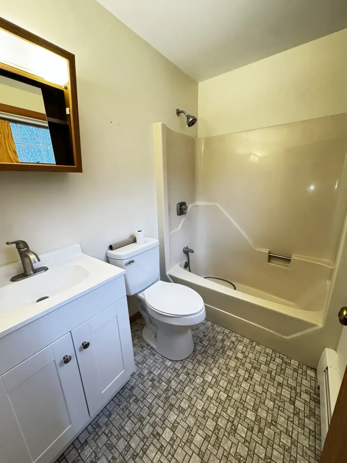Full master bathroom remodel in Peabody, MA with a new vanity, toilet and tub-shower combo