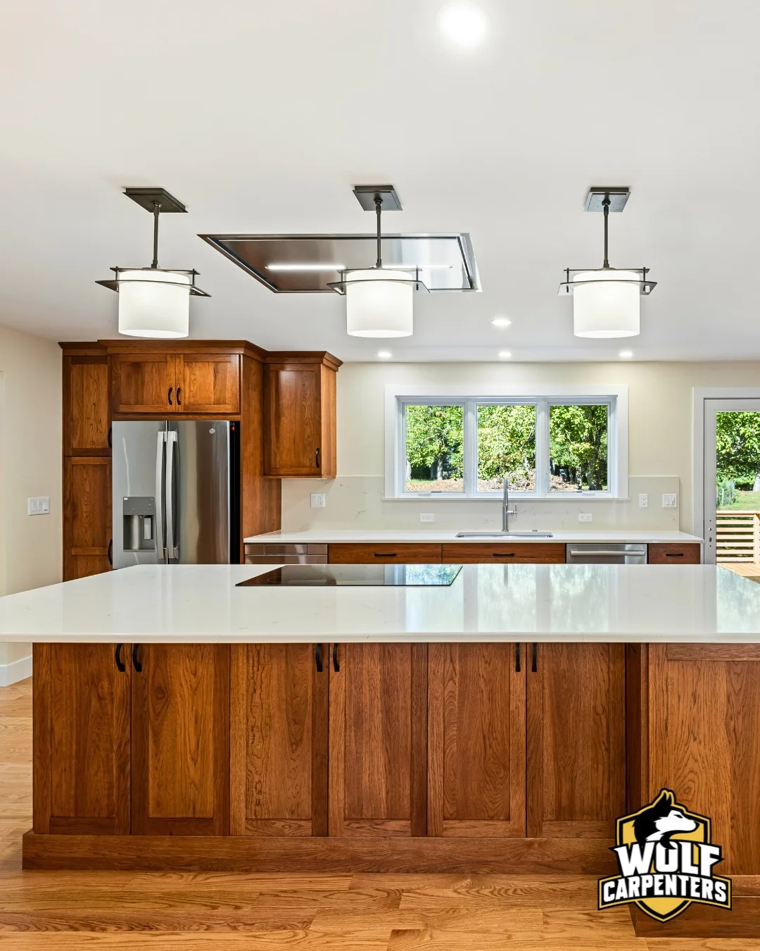 Open concept kitchen remodel with a large island and hardwood floors in North Andover, MA